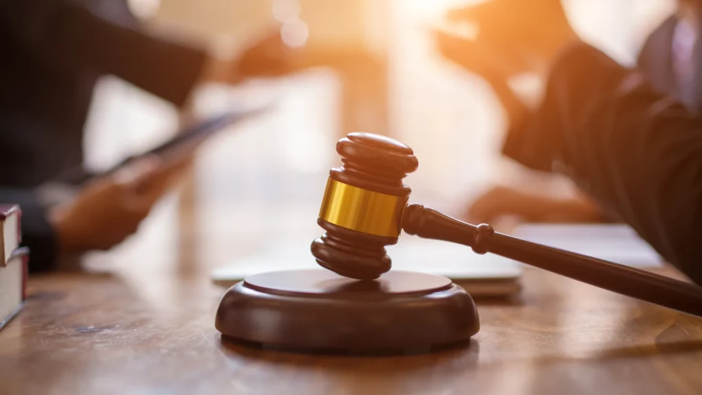 two cruise ship injury lawyers discussing a cruise ship injury case with a gavel in between them