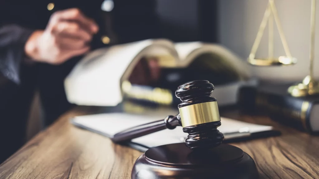 a cruise ship injury lawyer reviewing a textbook of cruise ship injury law with a gavel