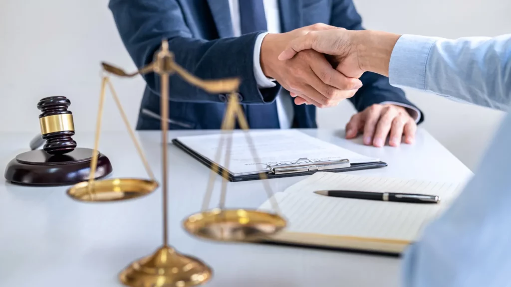 a cruise ship injury lawyer shaking the hand of a client whos family member fell overboard